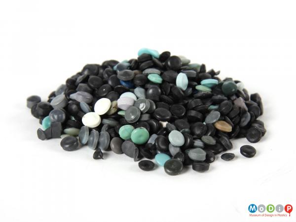 Side view of a pile of pellets showing the mainly black sample.