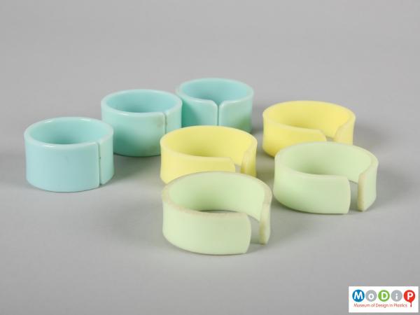 Side view of a number of napkin rings showing the three different colours.