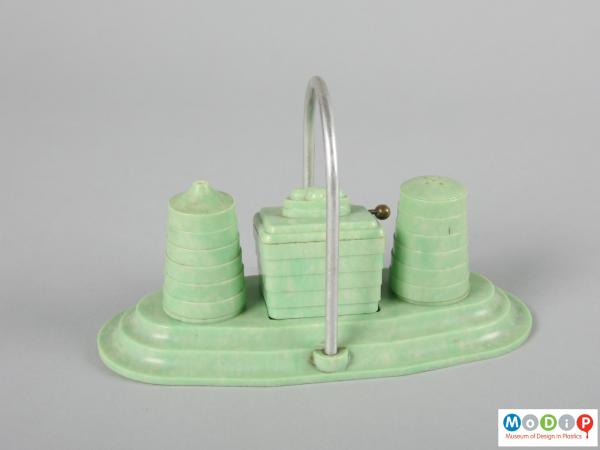 Side view of a cruet set showing the pieces on the stand.