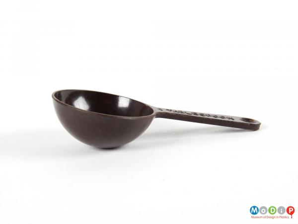 Side view of a spoon showing the hemi-spherical bowl and thin handle.