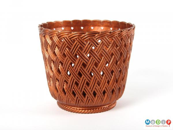 Side view of a plant pot holder showing the basket weave moulded patterning.