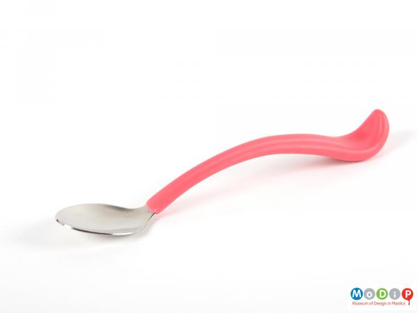 Side view of a spoon showing the long curving handle.