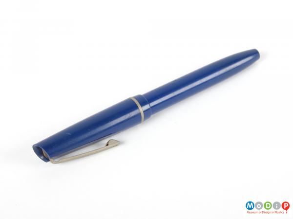 Side view of a pen showing the metal trimmed lid.