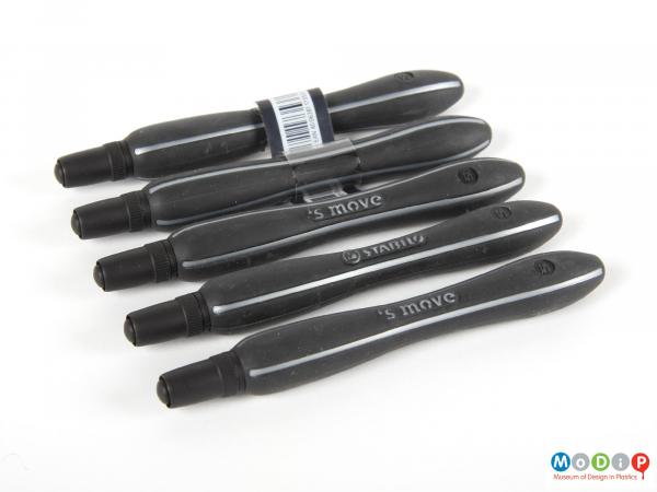 Side view of a set of pens showing the curved body shape.