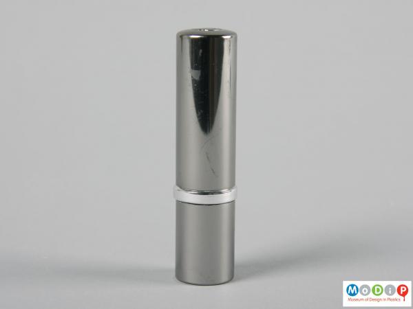 Side view of a lipstick tube showing the metallic cover.