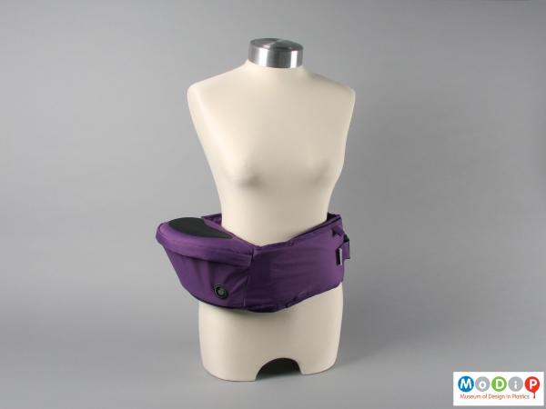 Side view of a hip seat showing it wrapped around a mannequin.