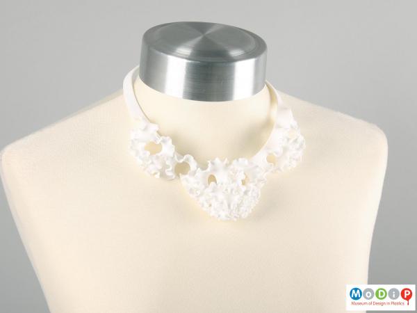 Front view of a necklace showing the ruffle design.
