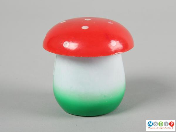 Side view of a set of tiddlywinks showing the toadstool shaped container.