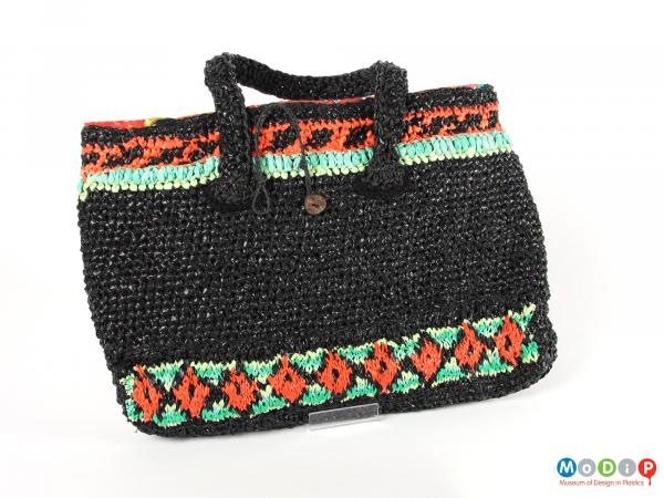 Side view of a bag showing the crocheted pattern.