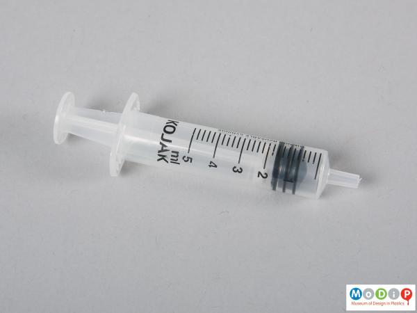 Side view of a syringe showing the printed demarcations.