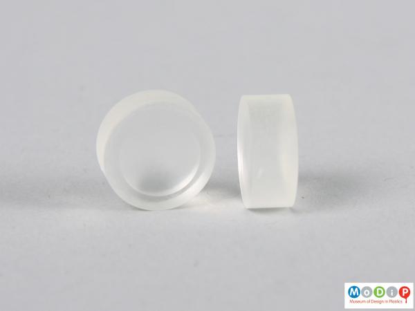 Side view of two blue contact lens buttons showing the thickness.