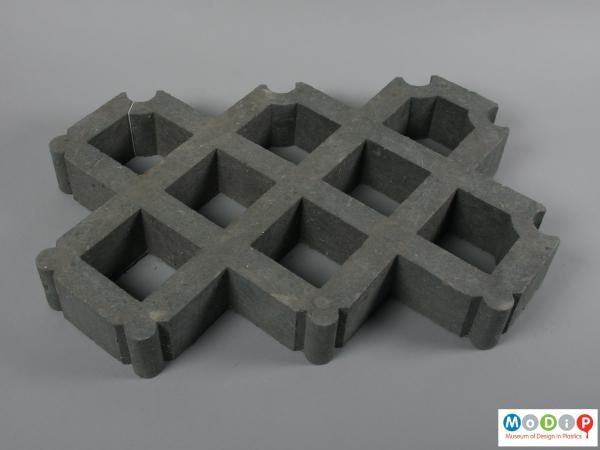 Top view of a paver showing interlocking grid pattern.