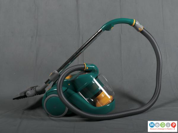 Side view of a vacuum cleaner showing the long flexible tube and straight wand.