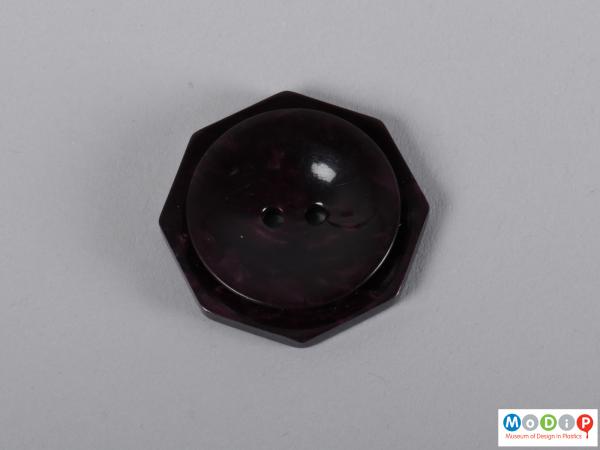 Front view of a button showing the octagonal shape.