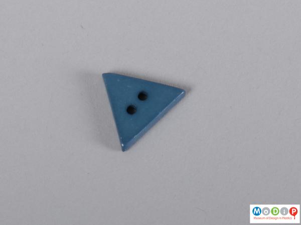 Front view of a button showing the triangular shape.