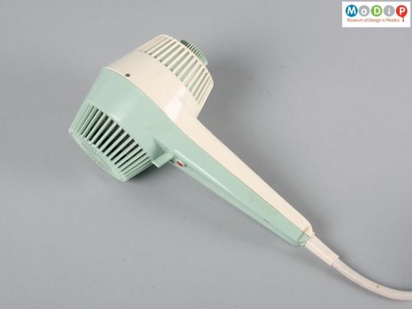 Side view of a hairdryer showing the long handle.