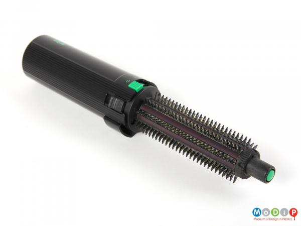 Side view of a Braun hair styler showing the wide plastic bristles at the brush end.