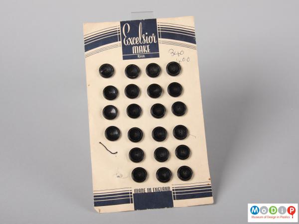 Front view of an Excelsior button card with four columns of buttons, the first column has two buttons missing from the bottom.
