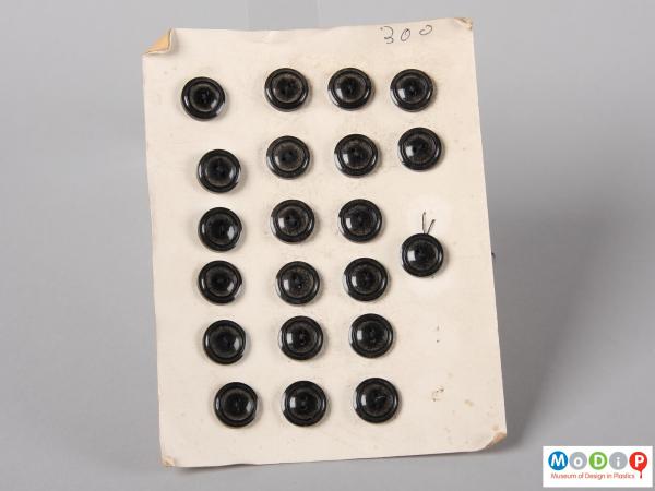 front view of a button sales card showing 4 columns of black buttons.