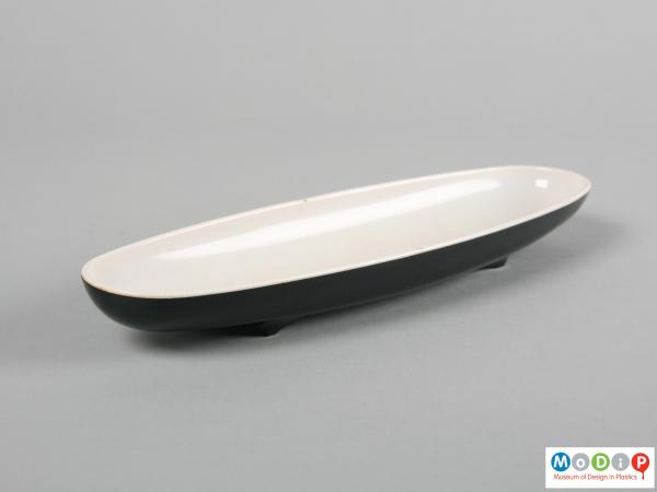 Side view of a tray showing the long thin shape.