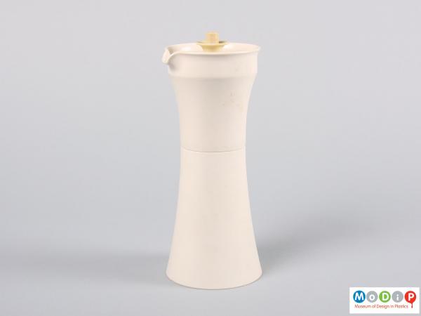 Side view of an oil or vinegar container showing the spout.