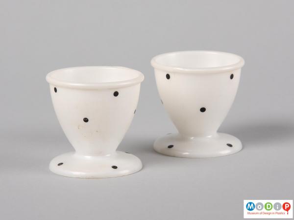 Side view of two MB egg cups showing the slender tapering in to the waist and out to the foot.