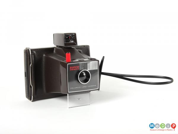 Side view of a Polaroid camera showing the lens housing and flash unit.