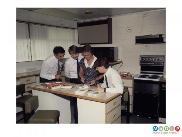 Scanned image showing a group of people testing ready meals.