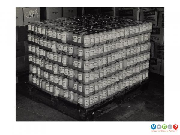 Scanned image showing a pallet load of jars shrink wrapped onto cardboard trays.