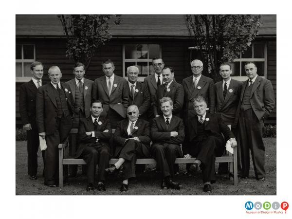 Scanned image showing a group of suited men.