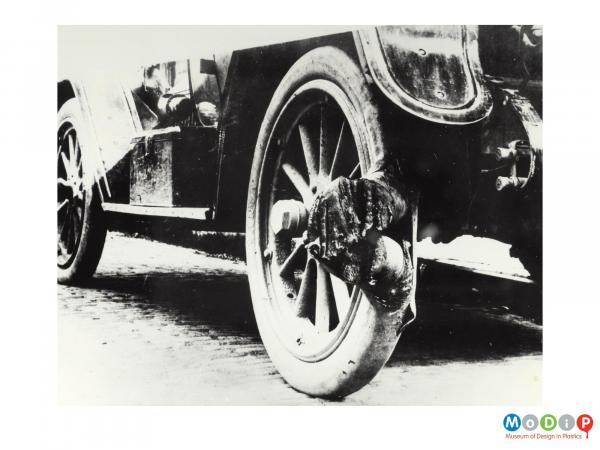 Scanned image showing a car with a tyre blow out.