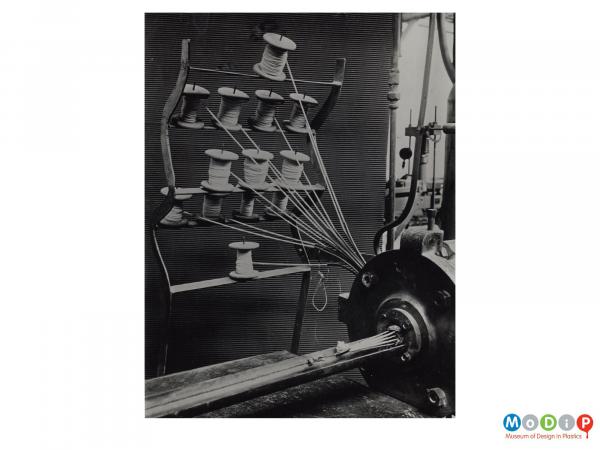 Scanned image showing a rack of bobbins.