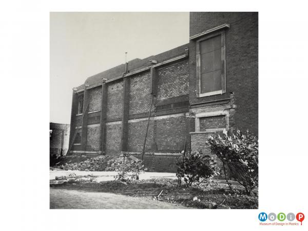 Scanned image showing the exterior of a derelict building.