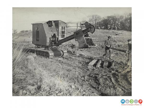 Scanned image showing a digger in a field.