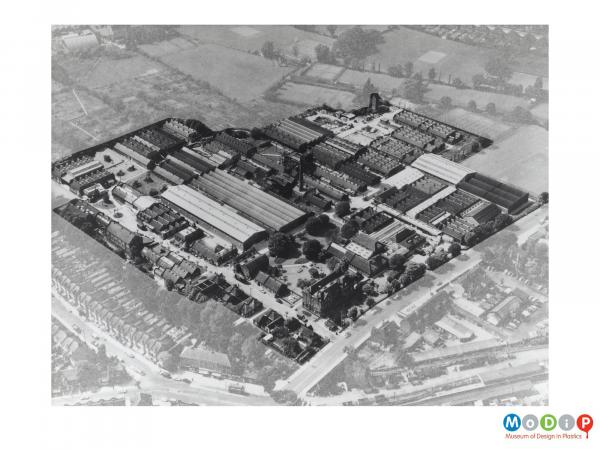 Scanned image showing an aerial view of factory buildings.