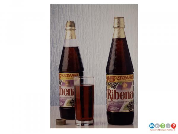 Scanned image showing two Ribena bottles along with a filled glass.