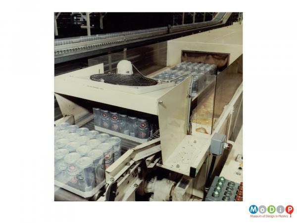 Scanned image showing beer cans on a packaging line.