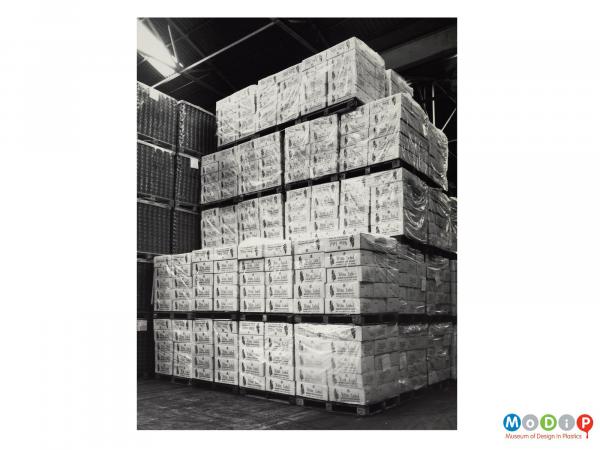 Scanned image showing pallet loads of whisky bottles in shrink wrapped boxes.