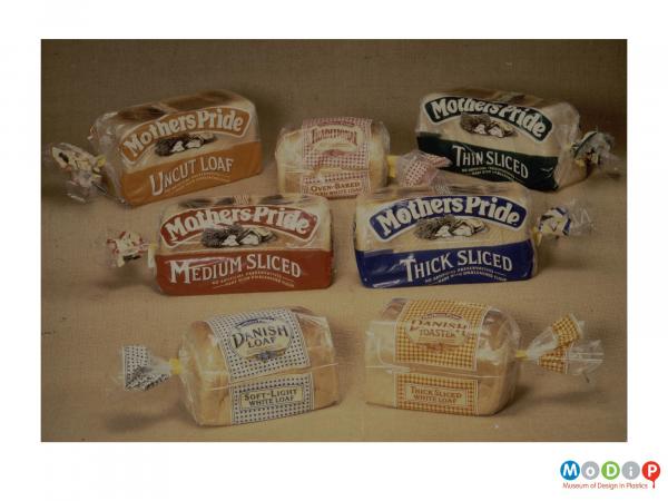 Scanned image showing a range of 8 different breads contained within clear plastic bags.