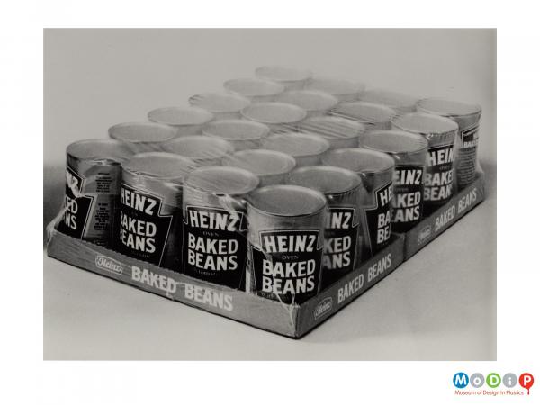 Scanned image showing 24 tins of Heinz Baked Beans shrink wrapped onto a cardboard base.