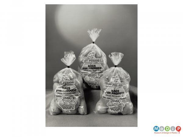 Scanned image showing three sacks of potatoes.