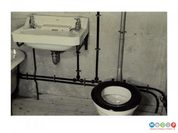 Scanned image showing pipework in a bathroom.