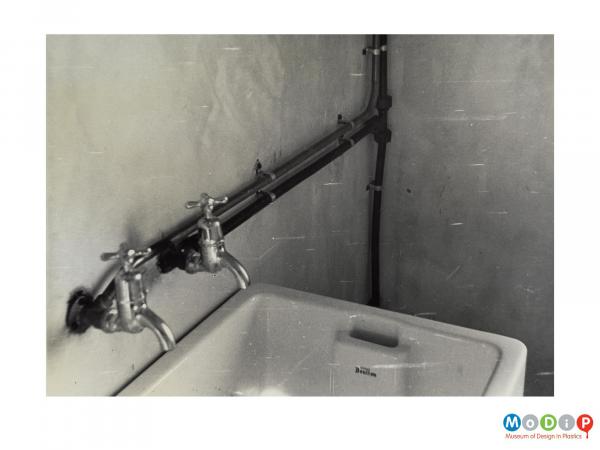 Scanned image showing pipework in a bathroom.