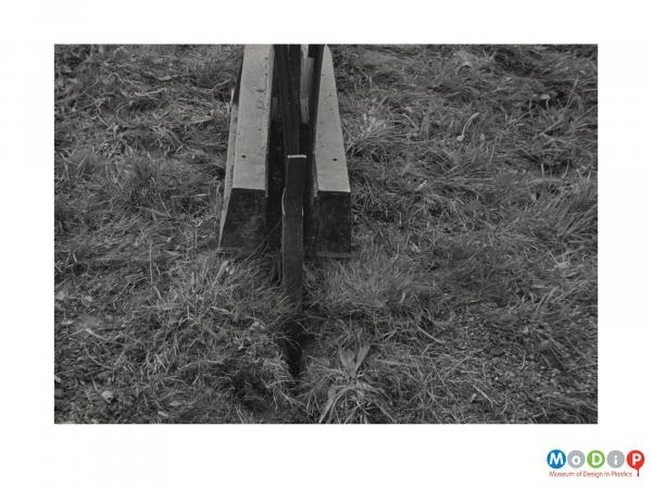 Scanned image showing a plough being used to  dig a trench.