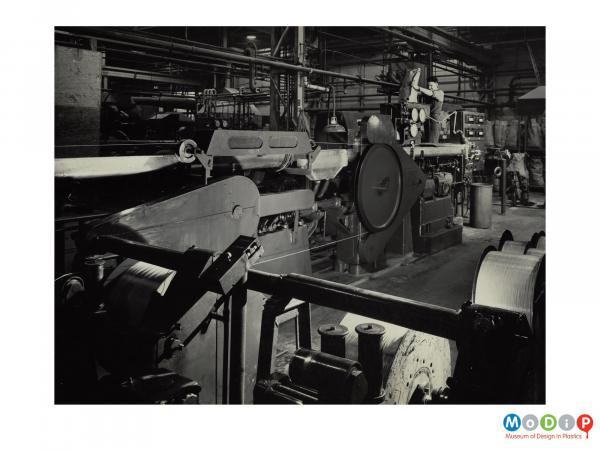 Scanned image showing a large machine producing polythene thread.