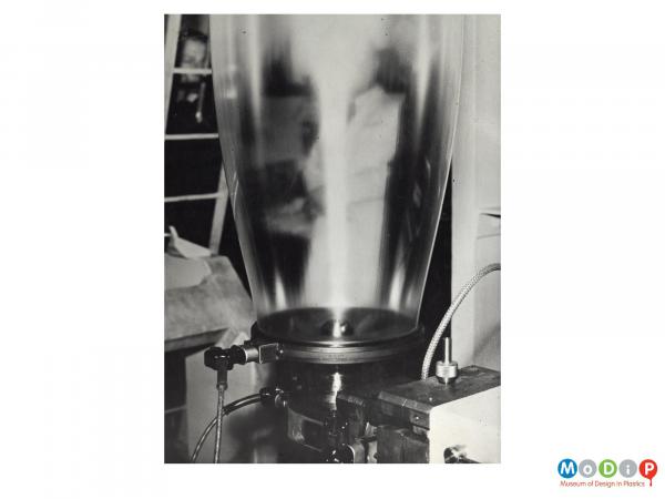 Scanned image showing a tube of film being extruded.