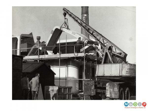 Scanned image showing a cabin cruiser being built.