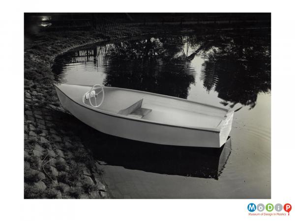 Scanned image showing a small motor boat on the water.
