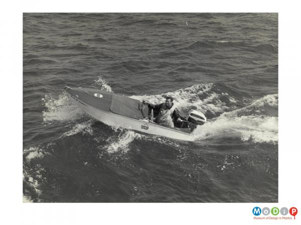 Scanned image showing a small motor boat.