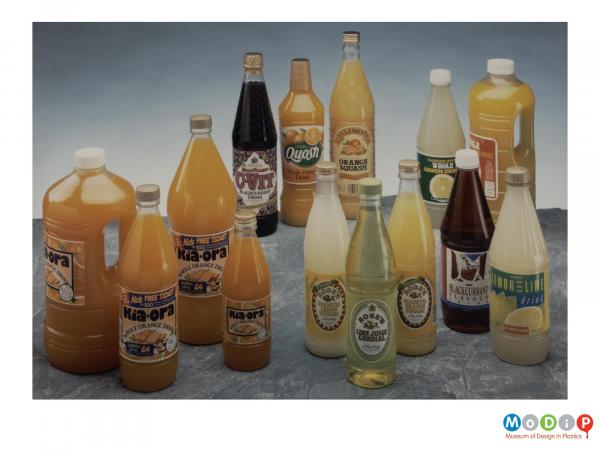 Scanned image showing a range of 14 soft drinks bottles.